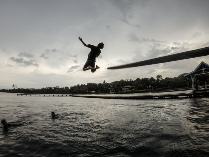 Full length of man jumping in sea