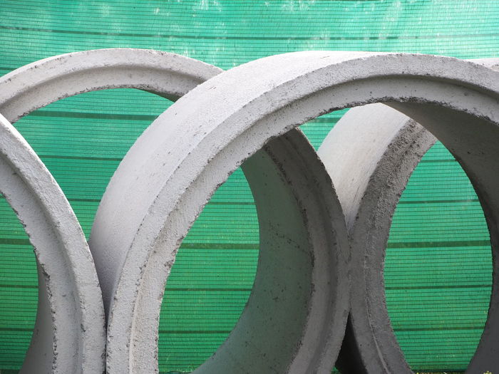 The concrete tube put forward green background