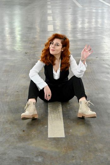 Portrait of a young woman sitting on floor