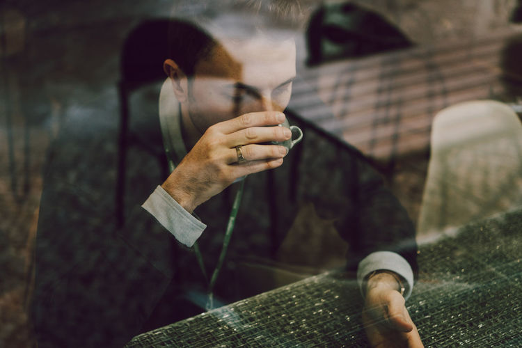 Close-up of man holding cigarette