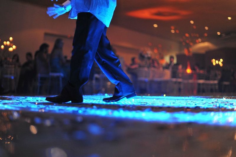 Low section of man dancing during wedding reception