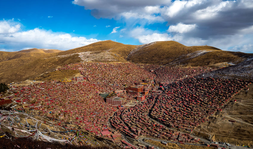 High angle view of land and mountains against sky