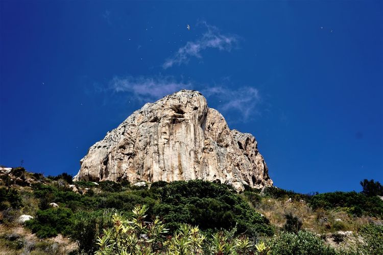 Low angle view of rock formation against sky