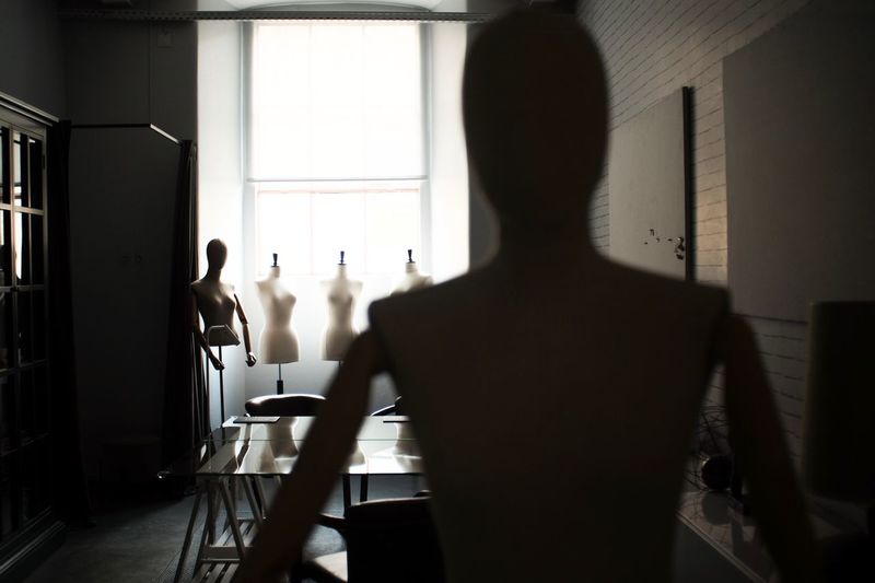 Female mannequins placed against window in workshop