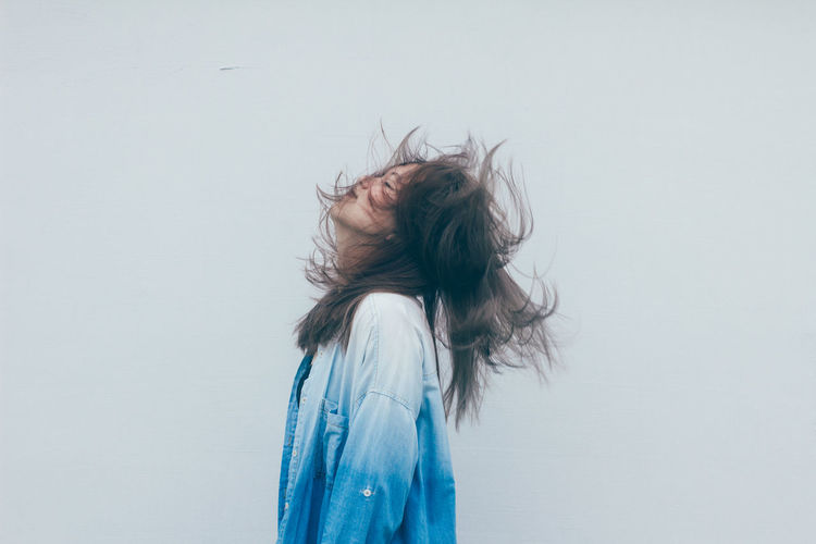 Close-up of woman against white background
