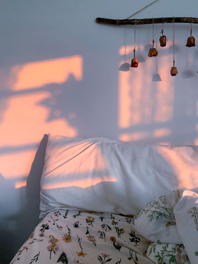 Aerial view of clothes hanging on bed against sky during sunset