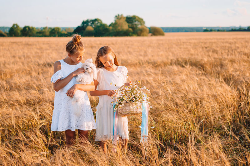 Mother and daughter standing on field