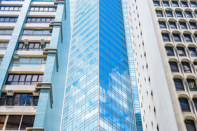 Low angle view of modern glass building in city