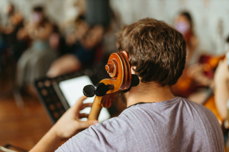 Rear view of man playing