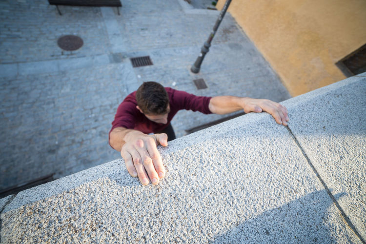 High angle view of man climbing wall