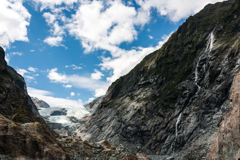 Low angle view of mountains against sky at franz josef glacier new zealand