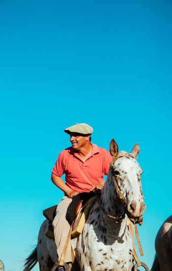 Portrait of man horseback riding