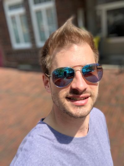 Portrait of smiling young man wearing sunglasses