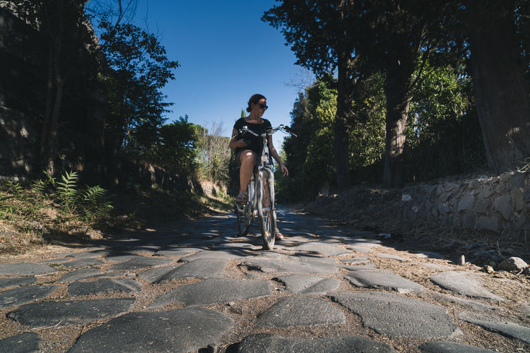 Cyclist on the ancient appian way, rome