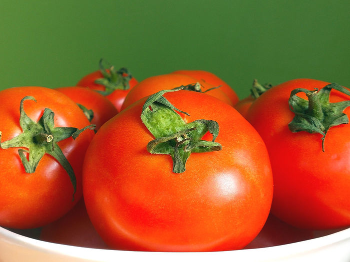 High angle view of tomatoes against orange background