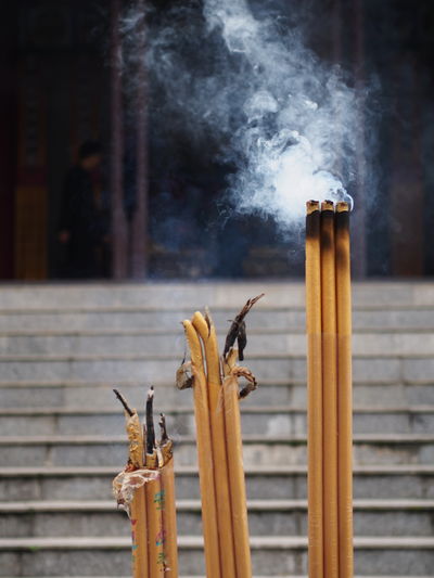 Close-up of smoke emitting from incense sticks
