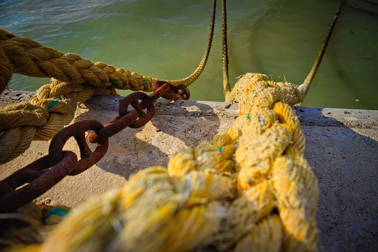 Close-up of rope tied up on rusty metal