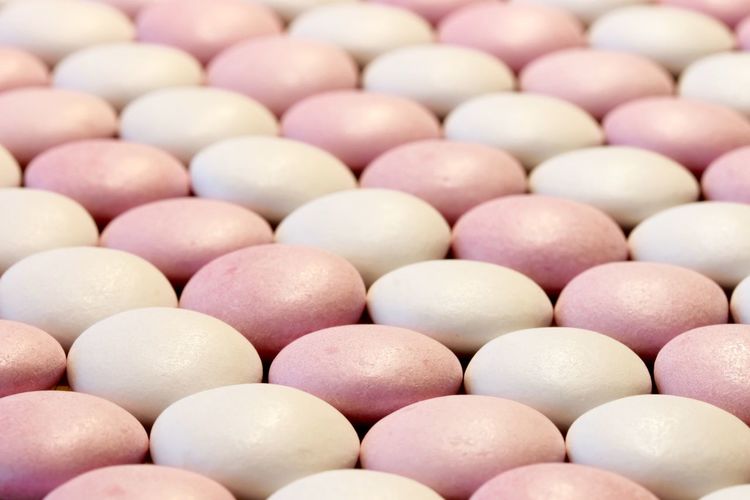 Full frame shot of pink and white macaroons