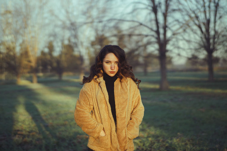 Young woman standing in park during winter