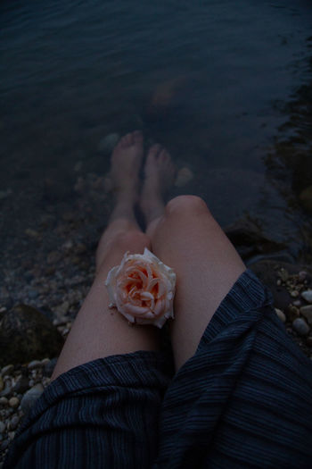 Low section of woman relaxing on beach