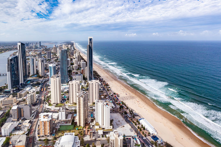 High angle view of sea and buildings against sky