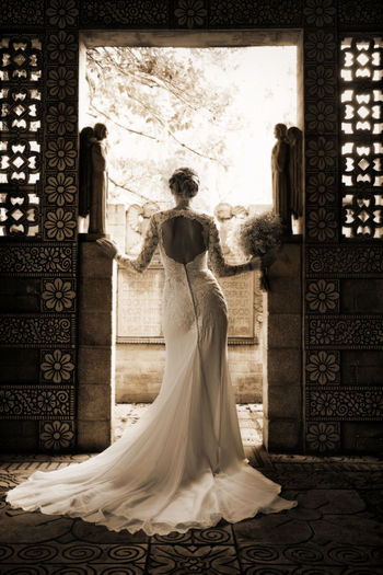 Rear view of bride standing in doorway