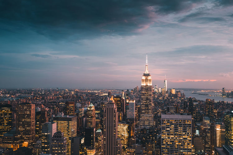 Illuminated cityscape against sky