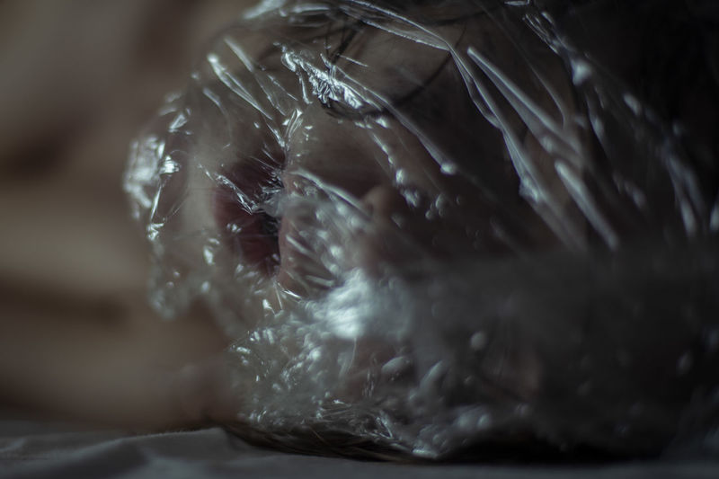 Close-up of woman wearing plastic bag