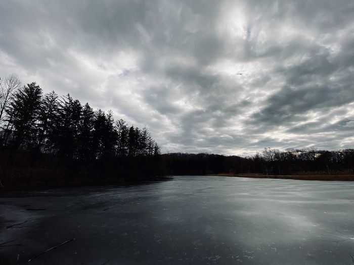 Scenic view of lake against sky during winter