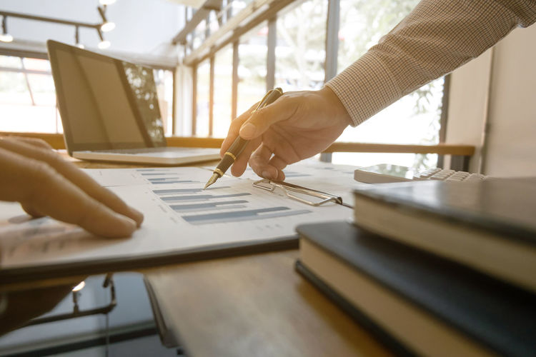 Close-up of business colleagues working in office