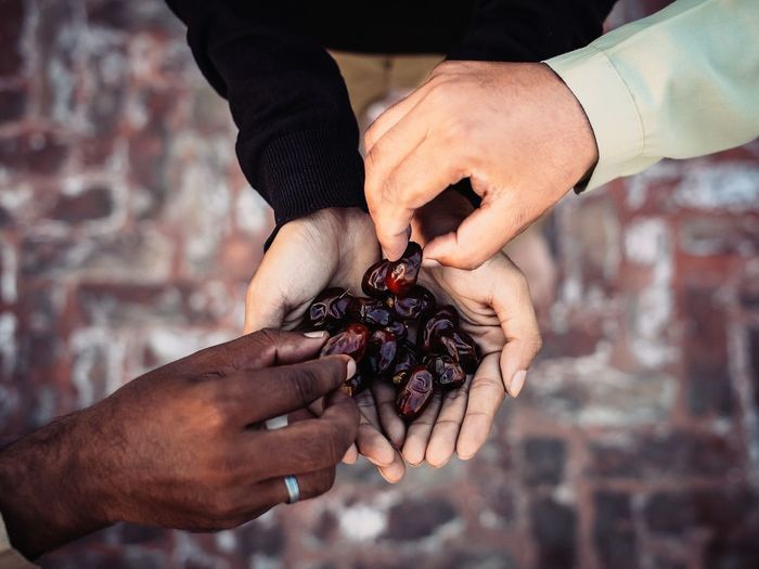 Directly above shot of hands holding date fruit during ramadan