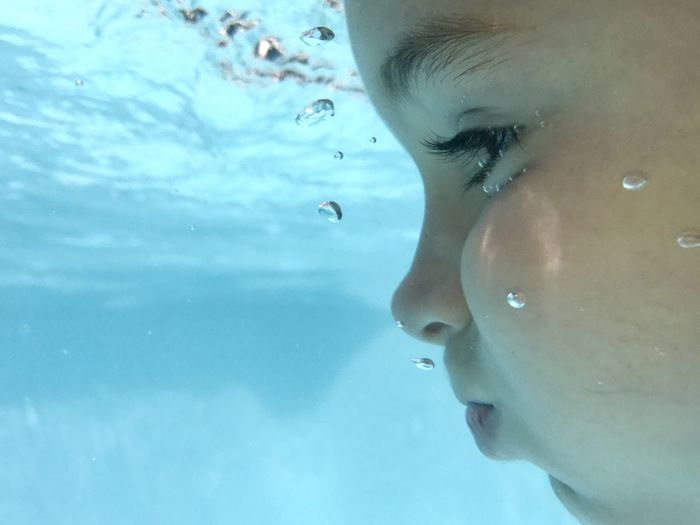 Close-up of girl swimming in pool