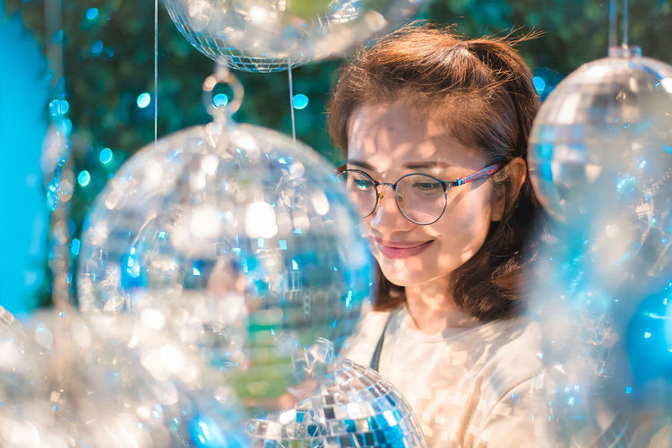 Smiling young woman amidst christmas decoration