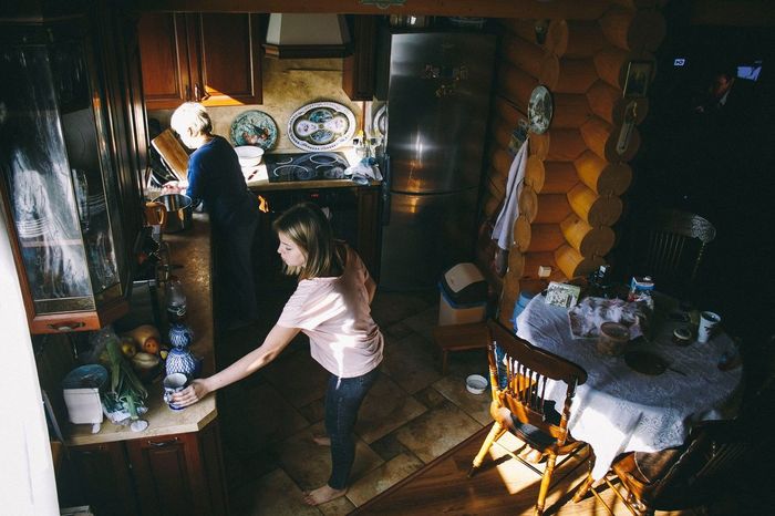 High angle view of daughter helping mother in kitchen at home