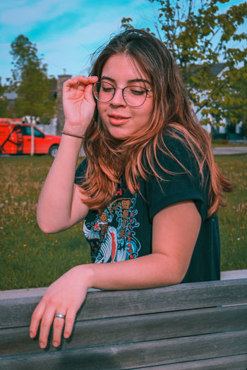 Portrait of a young woman sitting outdoors