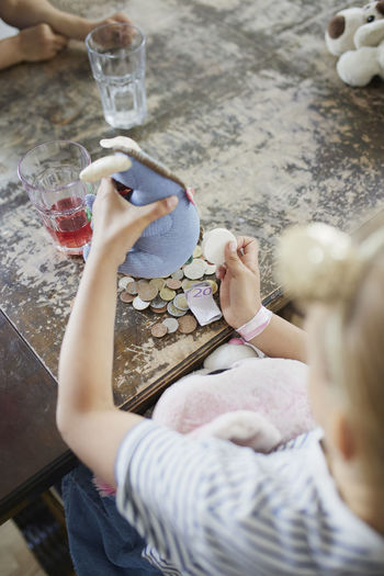 Girl counting savings on table