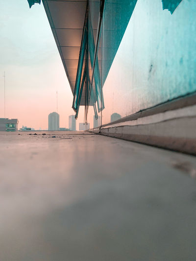 Scenic view of sunset by building against sky