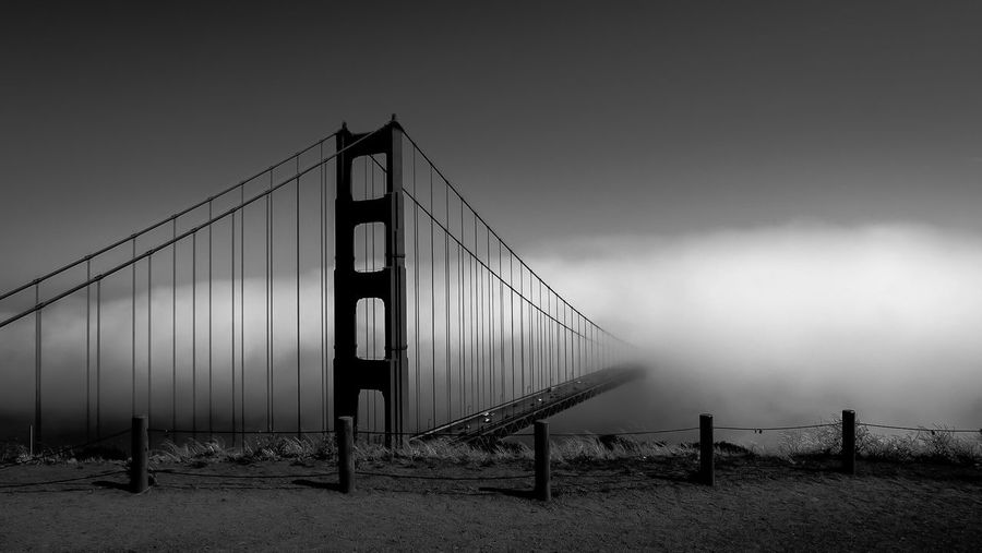 Fog coming over the golden gate bridge. black and white view  from battery spencer, sausalito, ca.