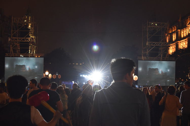 Crowd on illuminated street during event at night