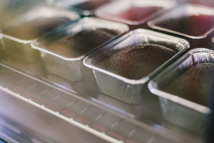 High angle view of cakes in containers on cooling rack