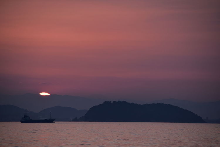 Scenic view of sea against romantic sky at sunset