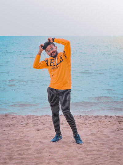 Full length of man standing on beach