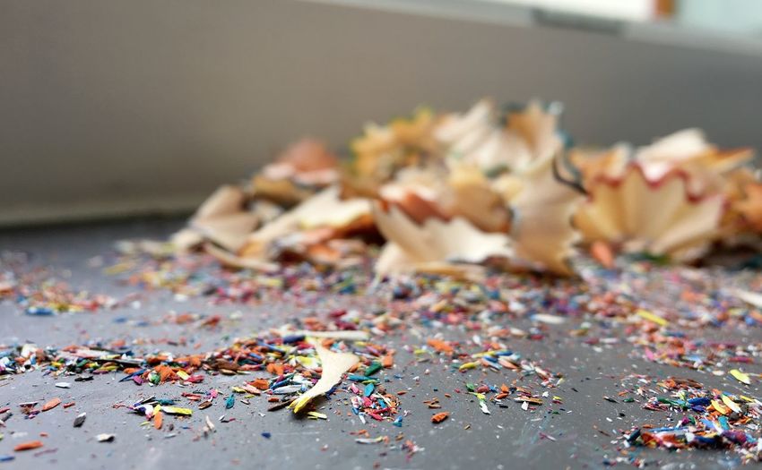 Close-up of multi colored pencil shavings on table