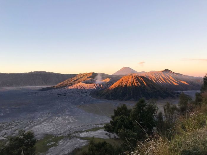 Scenic view of volcanic landscape against sky during sunrise