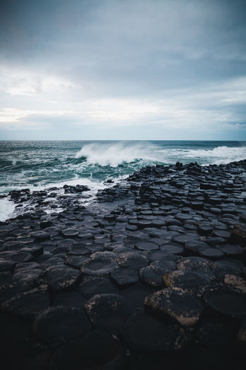 Scenic view of giants causeway against sky