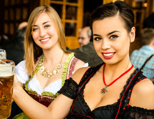 Portrait of happy women enjoying beer at oktoberfest