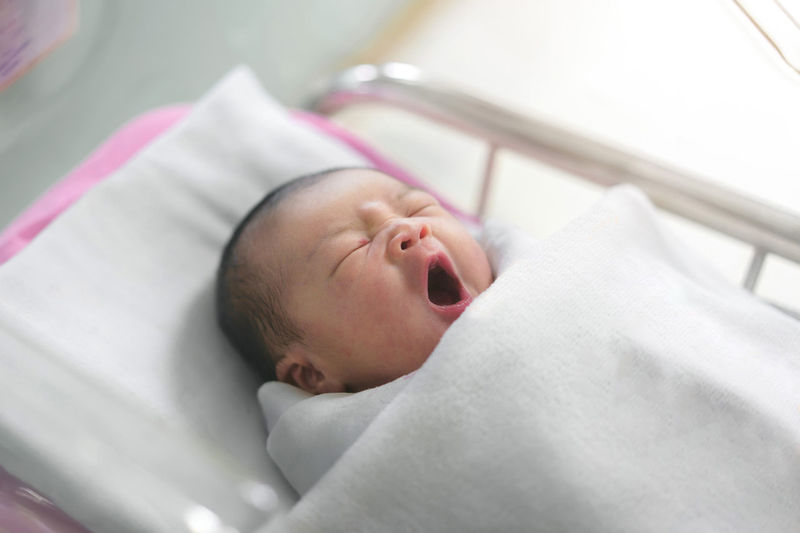Cute baby lying on bed
