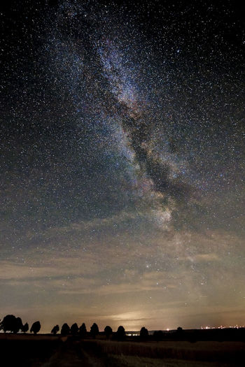 Scenic view of field against sky at night