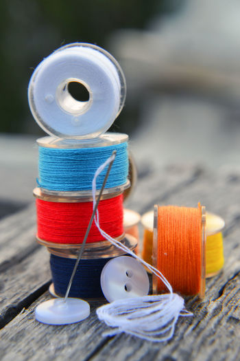 Close-up of multi colored sewing items on table