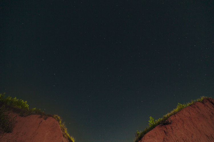 LOW ANGLE VIEW OF STAR FIELD AGAINST SKY AT NIGHT